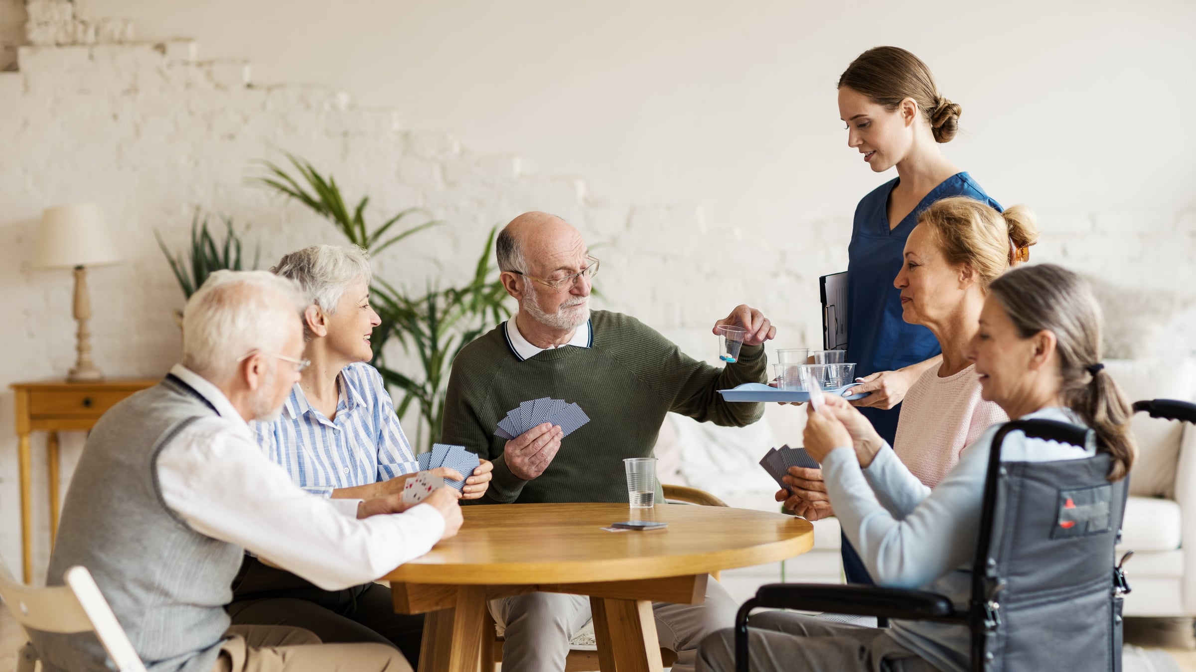 Residents playing cards together in the living room